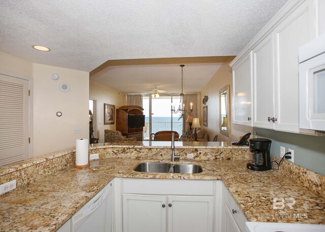 527 Beach Club Trl Unit C1006, Gulf Shores, AL 36542 - kitchen featuring a sink, a ceiling fan, white appliances, a textured ceiling, and white cabinets
