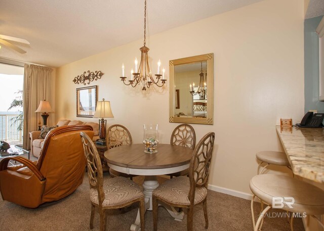 527 Beach Club Trl Unit C1006, Gulf Shores, AL 36542 - dining area with ceiling fan with notable chandelier, carpet, and baseboards