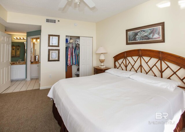 527 Beach Club Trl Unit C1006, Gulf Shores, AL 36542 - bedroom with light tile patterned floors, light colored carpet, visible vents, baseboards, and a closet