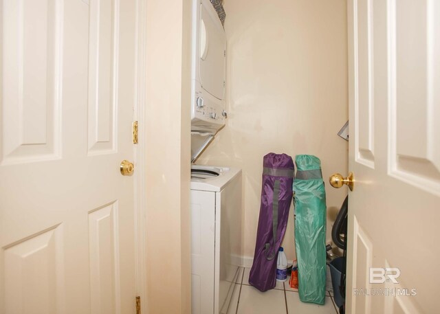 527 Beach Club Trl Unit C1006, Gulf Shores, AL 36542 - laundry area with tile patterned flooring, stacked washing maching and dryer, and laundry area