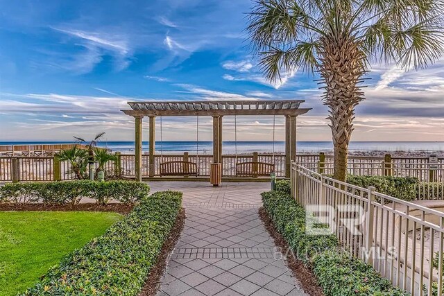 527 Beach Club Trl Unit C1006, Gulf Shores, AL 36542 - view of property's community with fence, a pergola, a water view, and a view of the beach