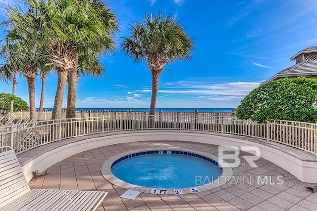 527 Beach Club Trl Unit C1006, Gulf Shores, AL 36542 - view of swimming pool with a fenced backyard, a water view, and an in ground hot tub