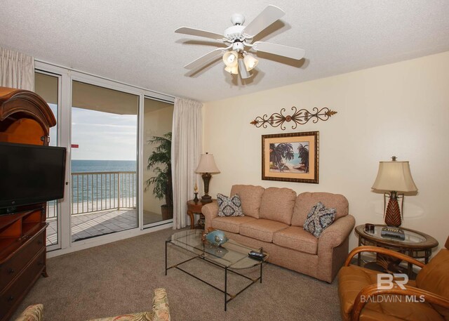 527 Beach Club Trl Unit C1006, Gulf Shores, AL 36542 - carpeted living area featuring a wall of windows, ceiling fan, and a textured ceiling