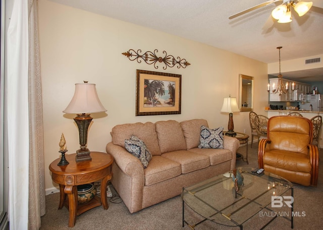 527 Beach Club Trl Unit C1006, Gulf Shores, AL 36542 - carpeted living room featuring visible vents and ceiling fan with notable chandelier