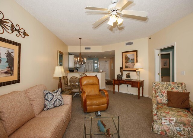 527 Beach Club Trl Unit C1006, Gulf Shores, AL 36542 - living room with visible vents, ceiling fan with notable chandelier, a textured ceiling, and carpet flooring