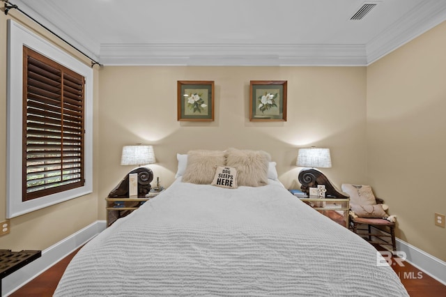 bedroom featuring crown molding, baseboards, visible vents, and dark wood-style flooring