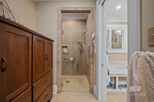 bathroom with a stall shower and ornamental molding