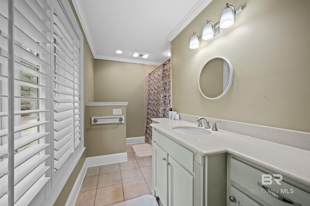 bathroom with visible vents, crown molding, baseboards, tile patterned floors, and vanity