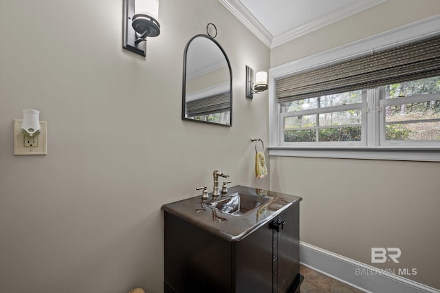 bathroom featuring a healthy amount of sunlight, vanity, crown molding, and baseboards