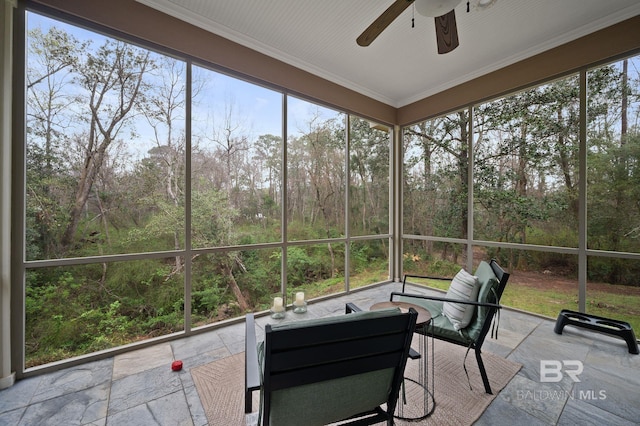 sunroom featuring a ceiling fan