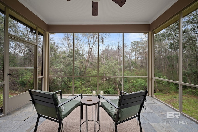 sunroom featuring a ceiling fan