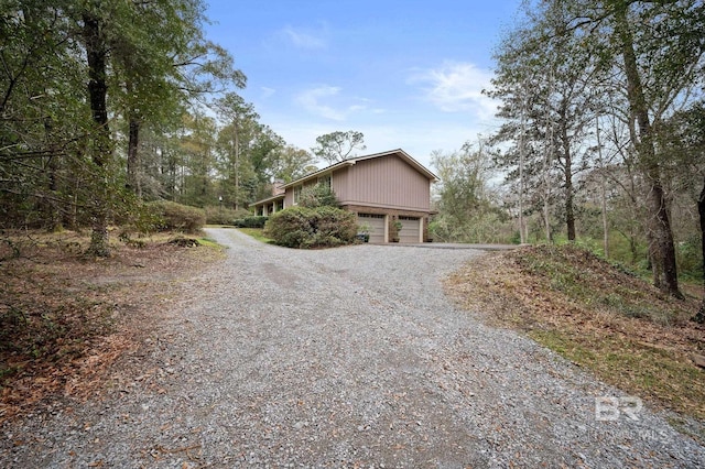 view of home's exterior with a garage and driveway