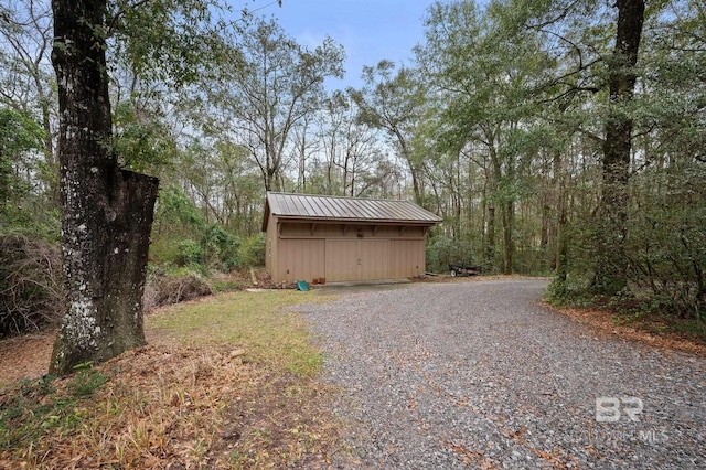 view of yard featuring driveway and an outdoor structure