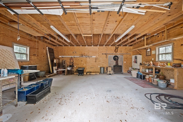 garage featuring a workshop area and a wood stove