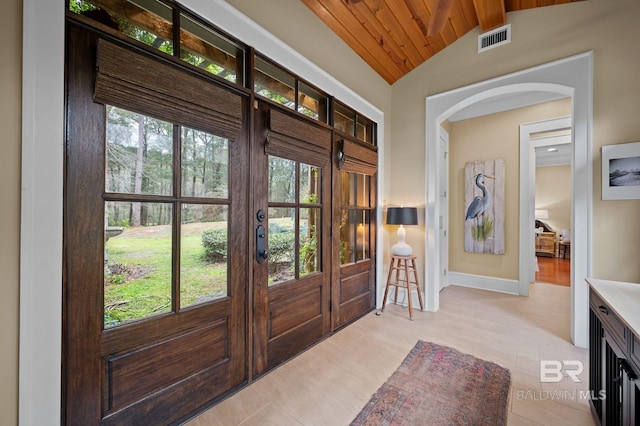 entryway featuring visible vents, baseboards, lofted ceiling, french doors, and arched walkways