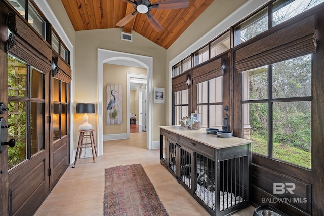 interior space featuring visible vents, baseboards, beamed ceiling, wooden ceiling, and arched walkways