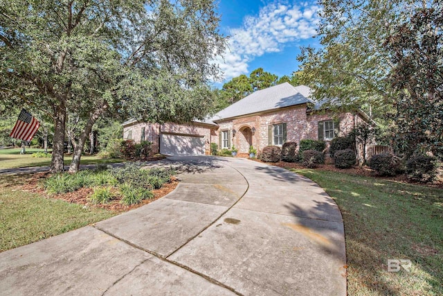 view of front of property featuring a garage and a front yard