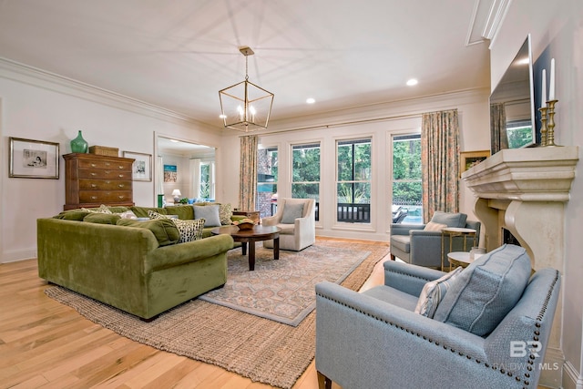 living room featuring wood-type flooring, an inviting chandelier, crown molding, and a high end fireplace