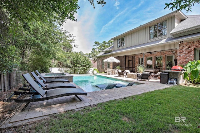 view of pool featuring an outdoor living space, a patio area, a lawn, and ceiling fan