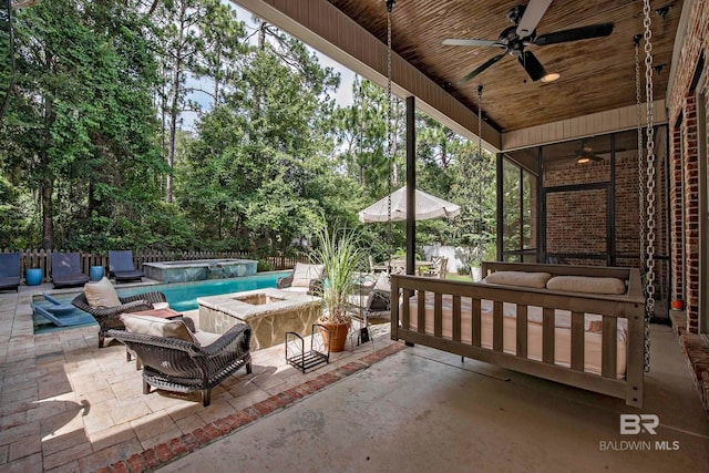 view of patio / terrace featuring a swimming pool with hot tub, ceiling fan, and an outdoor hangout area