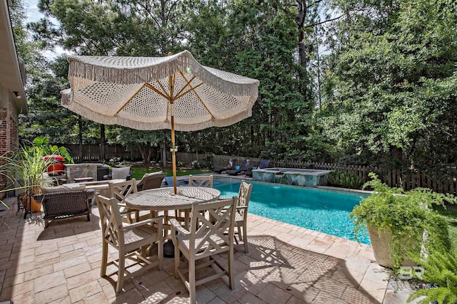 view of swimming pool with a patio and an in ground hot tub