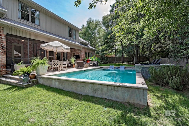 view of pool featuring a lawn, pool water feature, an outdoor hangout area, and a patio area