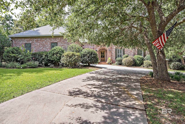 obstructed view of property with a front yard