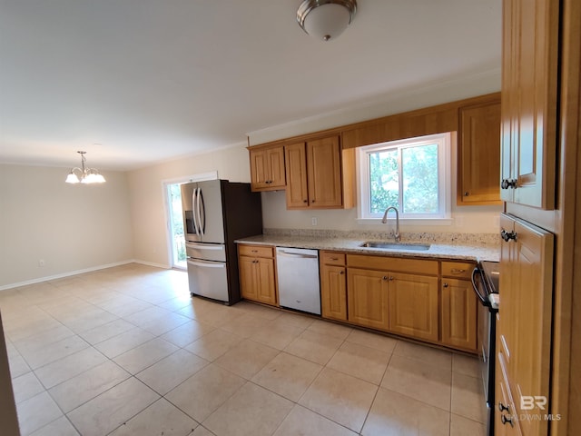 kitchen featuring stainless steel appliances, sink, decorative light fixtures, a notable chandelier, and light tile patterned flooring