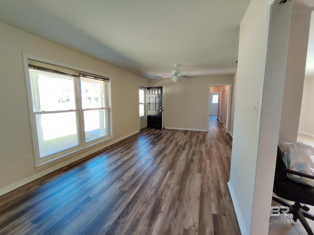 unfurnished living room with dark hardwood / wood-style floors, plenty of natural light, and ceiling fan