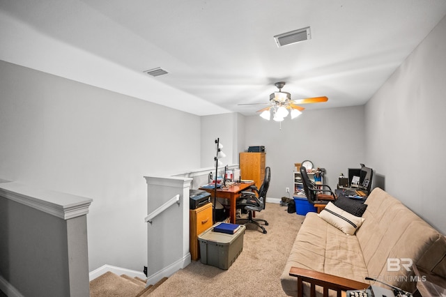 home office featuring baseboards, visible vents, and light colored carpet