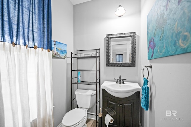 bathroom featuring toilet and vanity