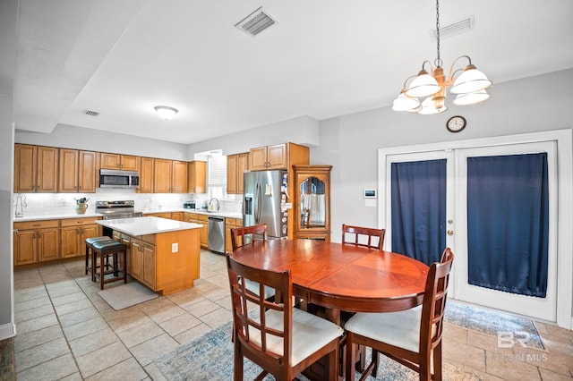 dining space with an inviting chandelier and visible vents