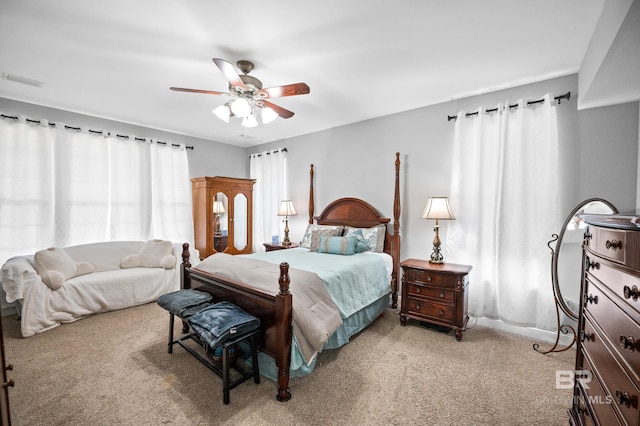 bedroom with a ceiling fan, light colored carpet, and visible vents