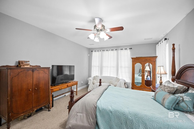 bedroom featuring light carpet, ceiling fan, and baseboards