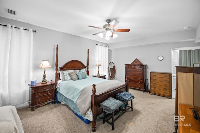 bedroom with ceiling fan, carpet flooring, and visible vents