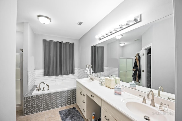 full bathroom featuring a sink, visible vents, a shower stall, a bath, and tile patterned floors