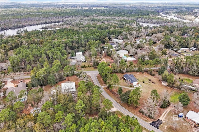 bird's eye view with a water view and a view of trees