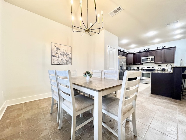 14775 Sonoma Blvd, Silverhill, AL 36576 - dining area with light tile patterned floors, visible vents, baseboards, and a notable chandelier