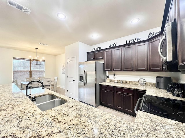 14775 Sonoma Blvd, Silverhill, AL 36576 - kitchen featuring visible vents, a sink, dark brown cabinetry, appliances with stainless steel finishes, and a notable chandelier