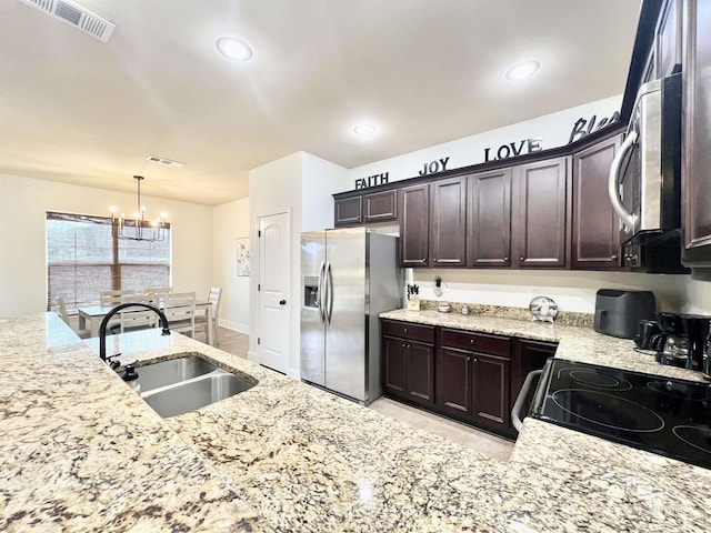 14775 Sonoma Blvd, Silverhill, AL 36576 - kitchen with visible vents, a sink, stainless steel appliances, dark brown cabinetry, and an inviting chandelier