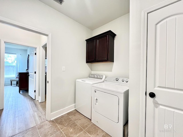 14775 Sonoma Blvd, Silverhill, AL 36576 - washroom with light tile patterned floors, cabinet space, independent washer and dryer, and baseboards