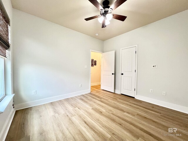 14775 Sonoma Blvd, Silverhill, AL 36576 - unfurnished bedroom featuring baseboards, light wood-type flooring, and ceiling fan