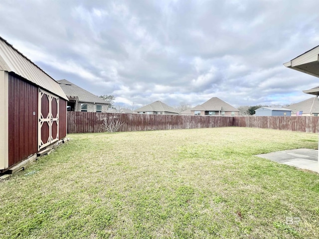14775 Sonoma Blvd, Silverhill, AL 36576 - view of yard featuring a storage unit, an outbuilding, and a fenced backyard