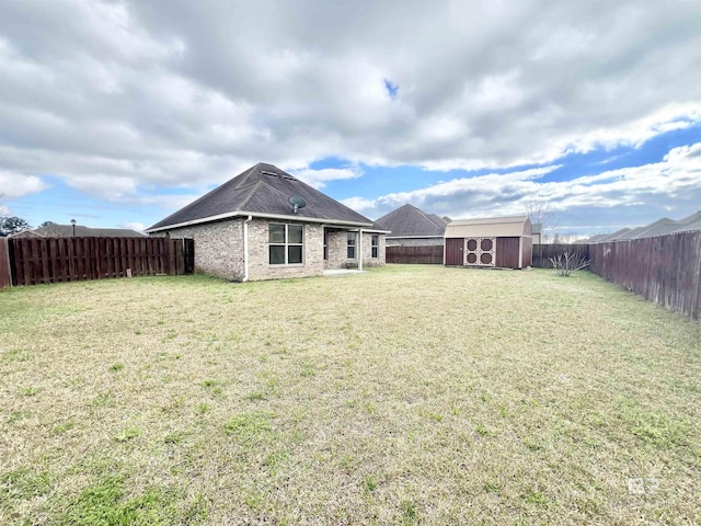 14775 Sonoma Blvd, Silverhill, AL 36576 - back of property with a yard, an outdoor structure, a fenced backyard, and a storage shed