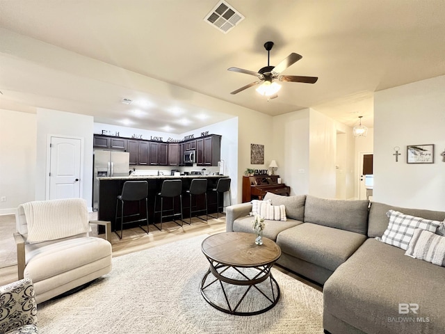 14775 Sonoma Blvd, Silverhill, AL 36576 - living room with baseboards, a ceiling fan, visible vents, and light wood-type flooring