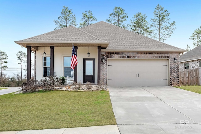 view of front of house featuring a porch, a garage, and a front lawn