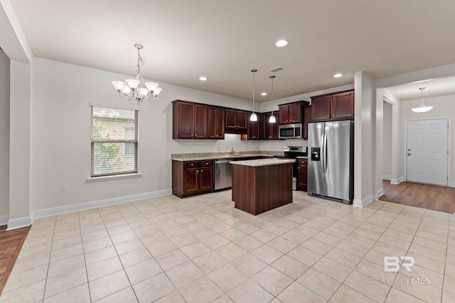 1464 Surrey Loop, Foley, AL 36535 - kitchen with appliances with stainless steel finishes, light countertops, a kitchen island, dark brown cabinets, and recessed lighting