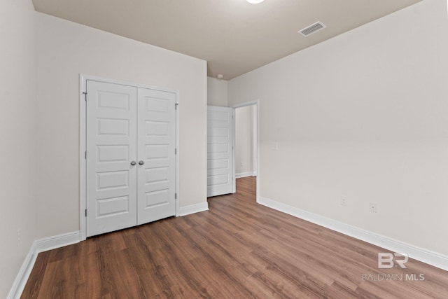 1464 Surrey Loop, Foley, AL 36535 - unfurnished bedroom with wood finished floors and a closet