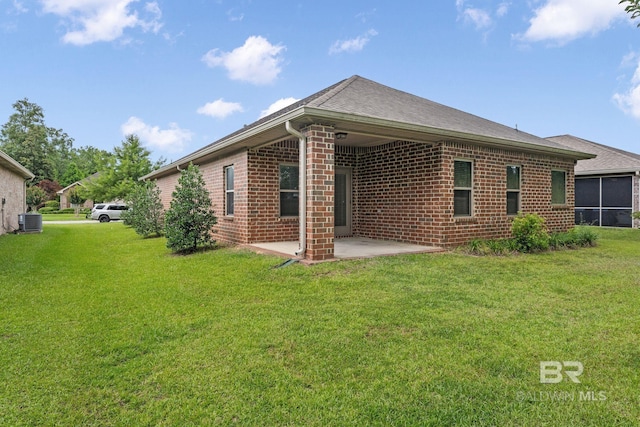 1464 Surrey Loop, Foley, AL 36535 - back of house featuring a patio, brick siding, a yard, and roof with shingles
