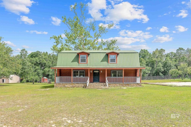 log home featuring covered porch, metal roof, a front lawn, and log exterior